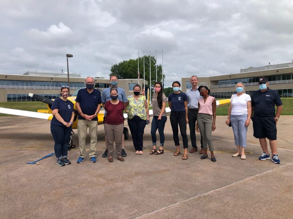 Jessica, Senator Harkin, and others pose after the Flight of Hope