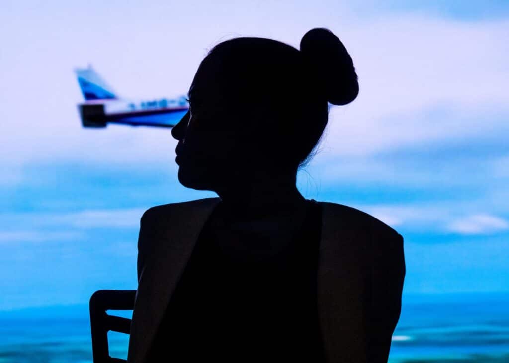 Jessica Cox silhouette in front of airplane shot